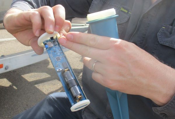 close-up of a water flow meter in a person's hand